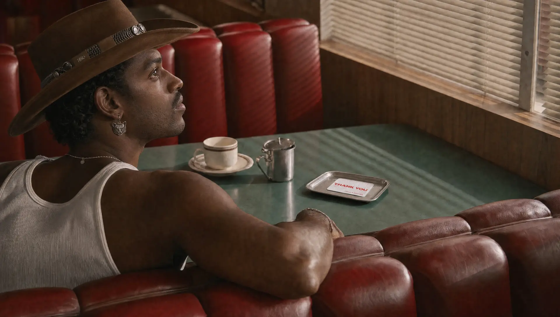 Man in a diner booth with an IRLs card on the table